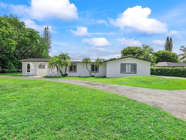 ranch-style house with a front lawn