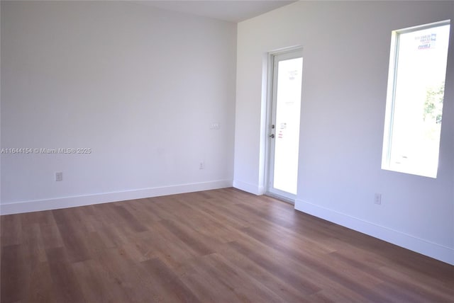 spare room with dark hardwood / wood-style flooring