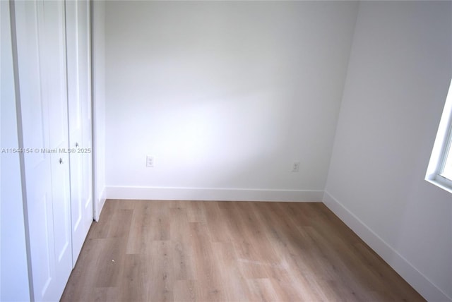 unfurnished room with light wood-type flooring