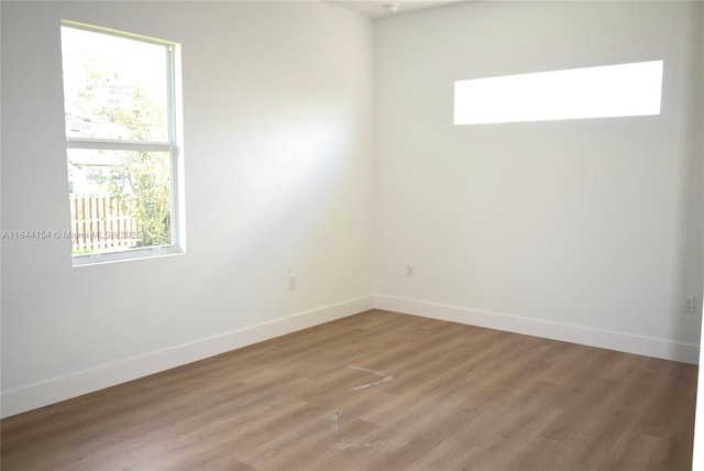 unfurnished room featuring hardwood / wood-style flooring