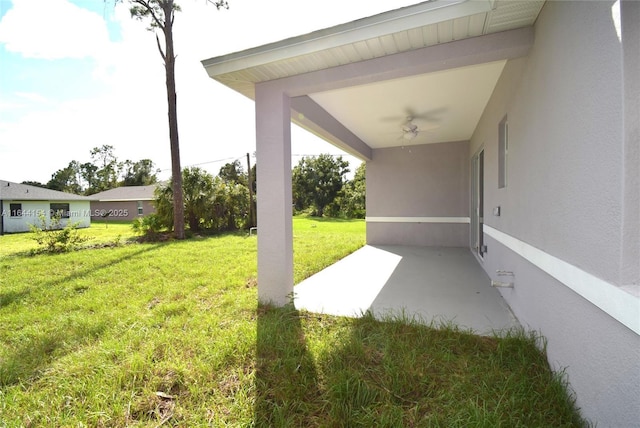 view of yard with ceiling fan