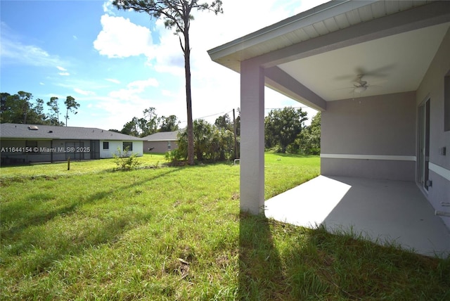 view of yard featuring ceiling fan and a patio