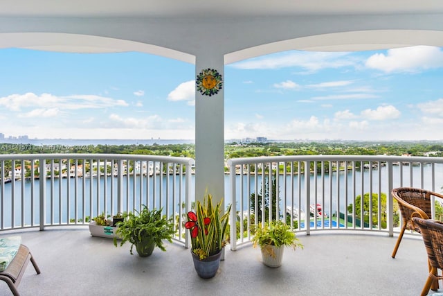 view of patio / terrace with a water view and a balcony