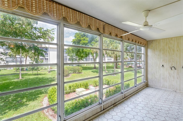 unfurnished sunroom featuring a wealth of natural light and ceiling fan