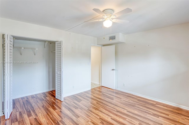 unfurnished bedroom featuring a closet, light hardwood / wood-style flooring, and ceiling fan