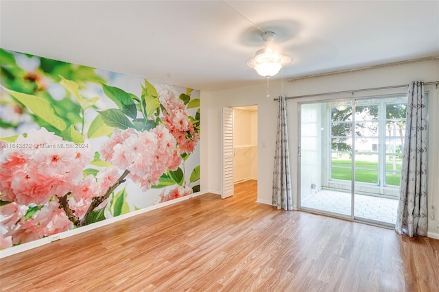 empty room with light hardwood / wood-style flooring and ceiling fan