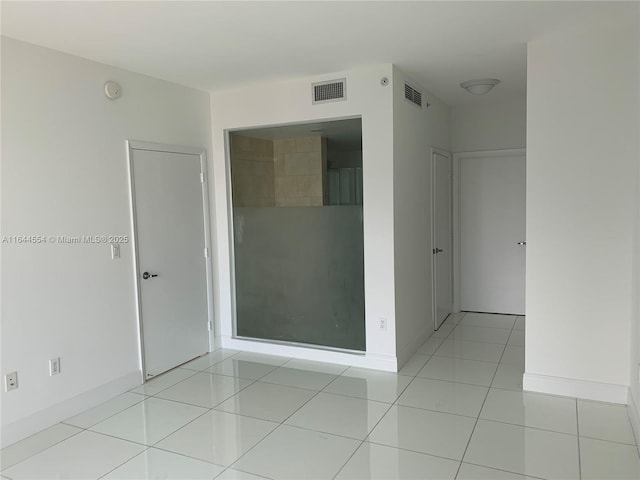 unfurnished room with light tile patterned floors