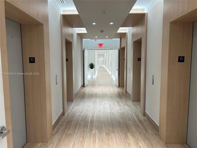 hallway featuring light hardwood / wood-style floors and elevator