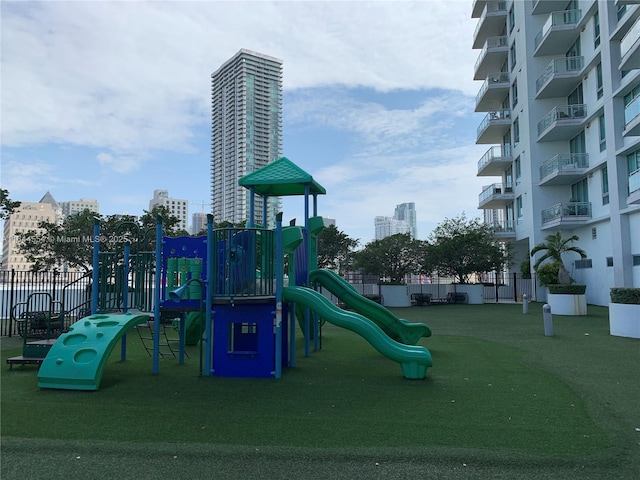 view of playground with a lawn