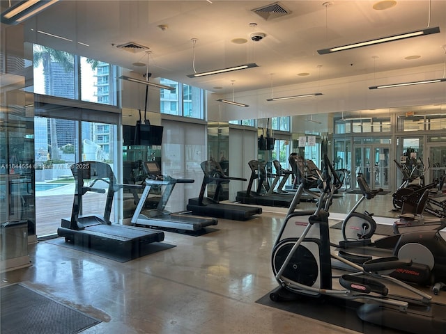 exercise room featuring a high ceiling