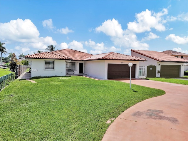 mediterranean / spanish house featuring concrete driveway, a tile roof, an attached garage, fence, and stucco siding