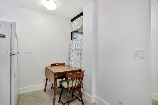 6219 Coral Lake Dr Unit 207, Margate, FL 33063 - dining area with light tile patterned floors, baseboards, and a textured ceiling