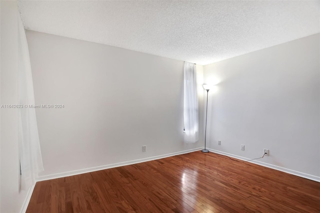 6219 Coral Lake Dr Unit 207, Margate, FL 33063 - spare room with baseboards, a textured ceiling, and hardwood / wood-style flooring