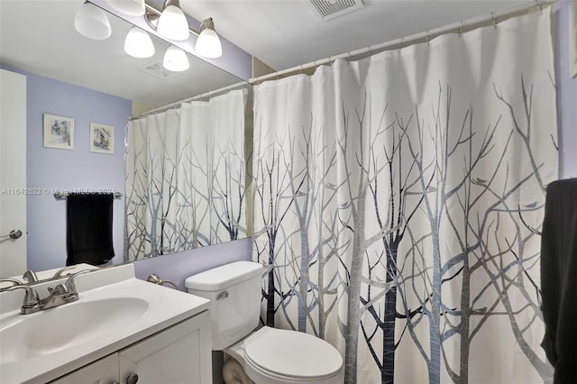 bathroom featuring toilet and vanity