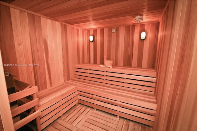 view of sauna / steam room featuring wood ceiling and wooden walls