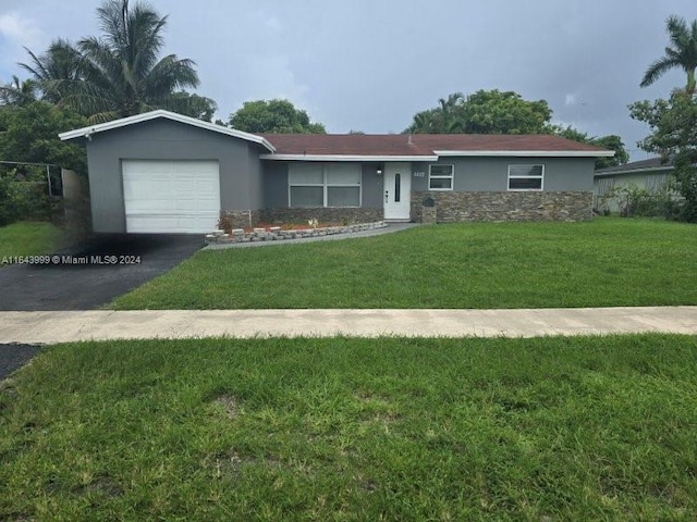 ranch-style house featuring a garage and a front yard