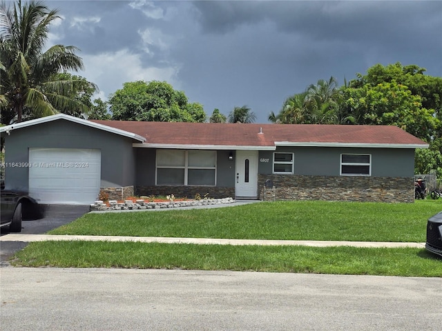 ranch-style house with stone siding, a garage, aphalt driveway, a front yard, and stucco siding