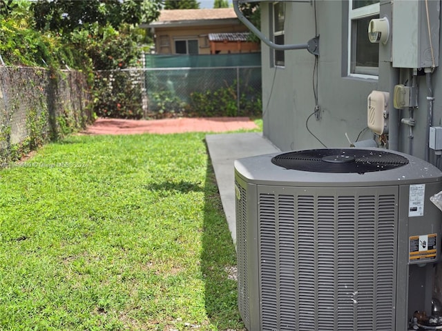 exterior details with a fenced backyard and central air condition unit