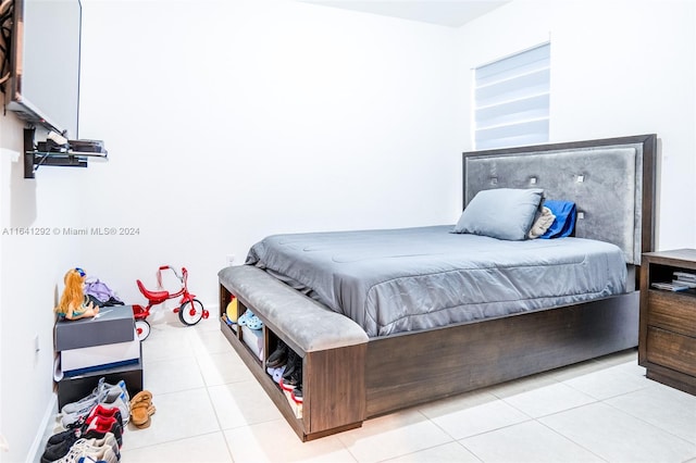 bedroom with light tile patterned floors