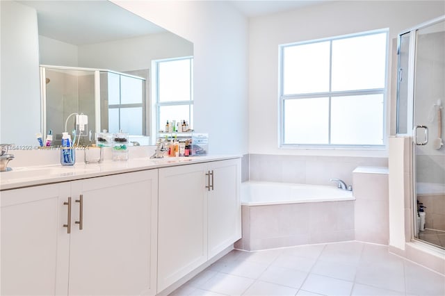 bathroom with double vanity, a sink, a stall shower, and tile patterned floors