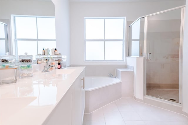 full bathroom featuring a stall shower, vanity, a garden tub, and tile patterned floors