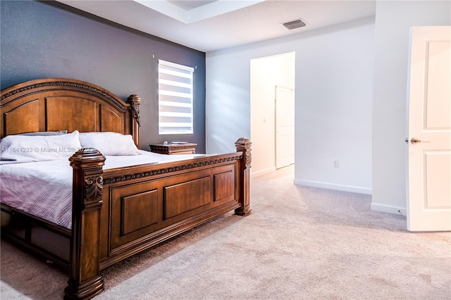 bedroom with baseboards, light carpet, and visible vents