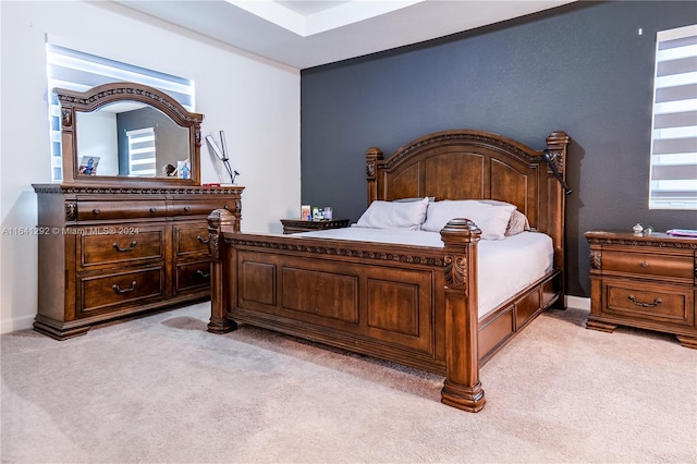 bedroom featuring baseboards and light carpet