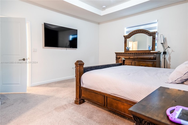 bedroom with baseboards and light carpet