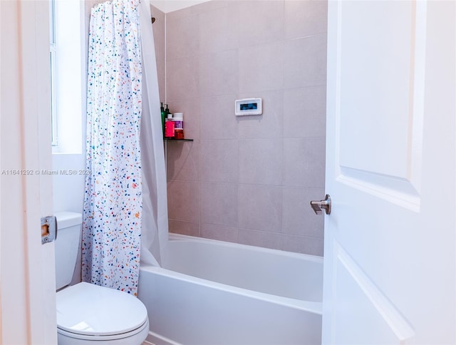 bathroom with shower / tub combo and toilet