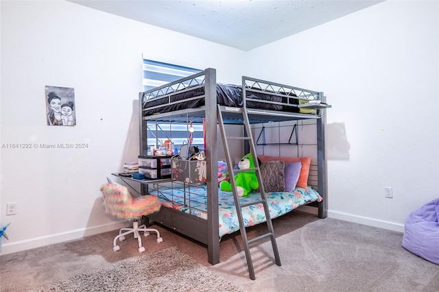 carpeted bedroom featuring baseboards