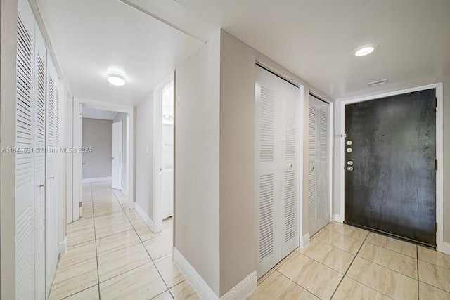 hall featuring light tile patterned floors