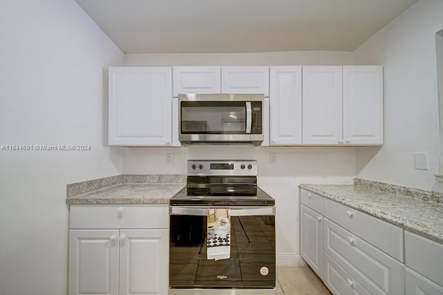 kitchen featuring stainless steel appliances and white cabinets