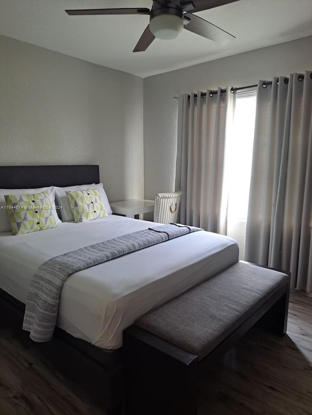 bedroom with ceiling fan and hardwood / wood-style flooring