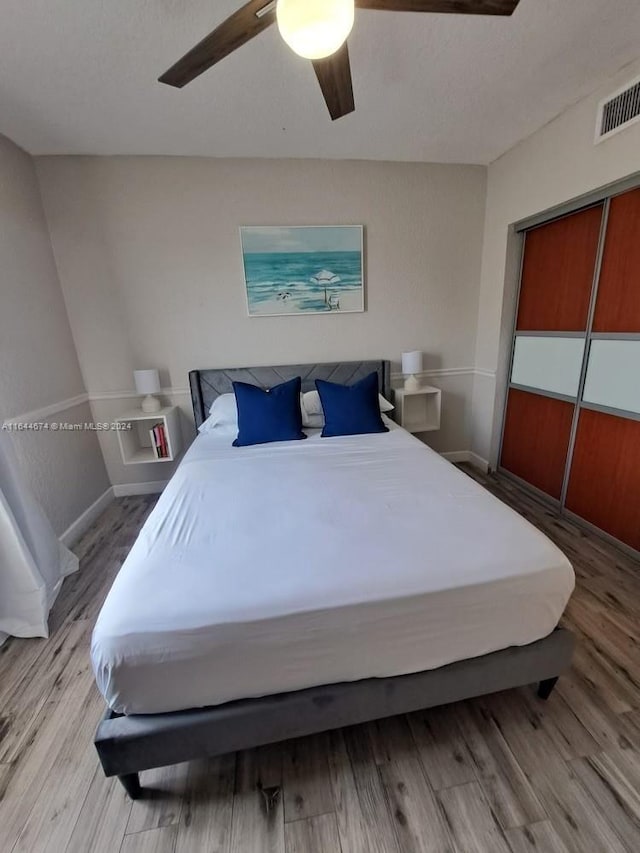 bedroom featuring ceiling fan and hardwood / wood-style floors