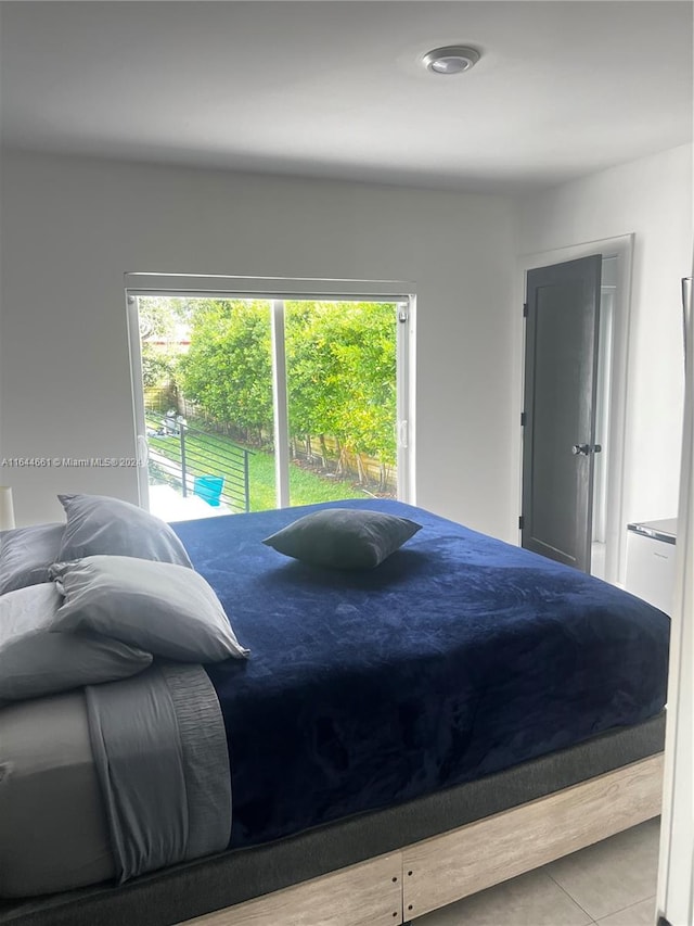 bedroom with light tile patterned floors