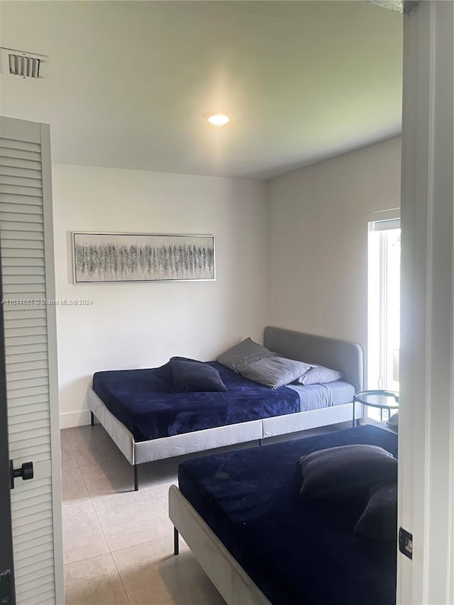 bedroom featuring light tile patterned flooring