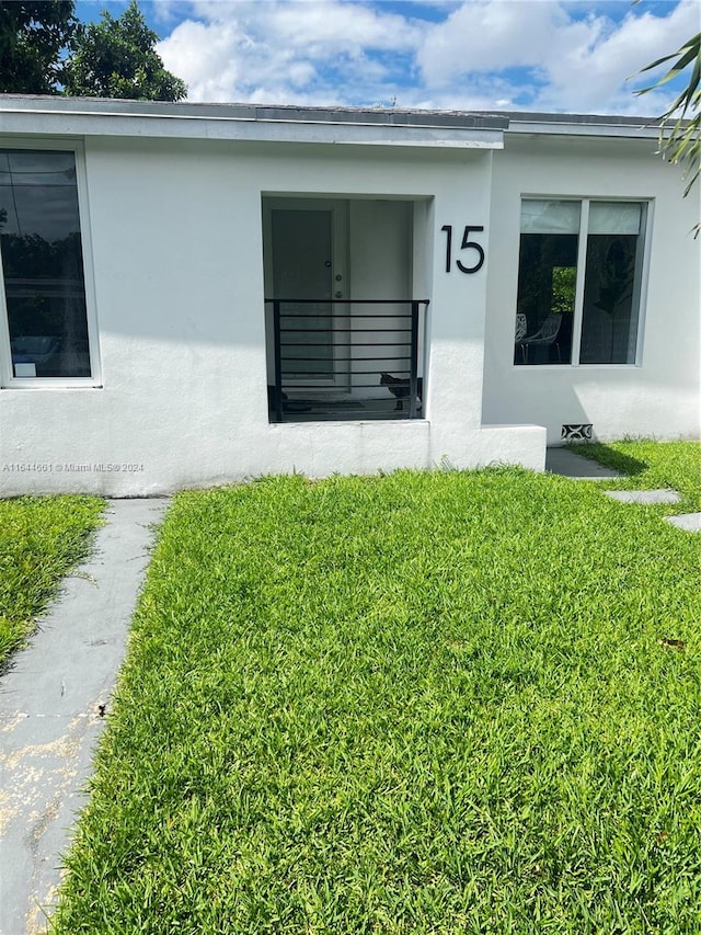 entrance to property featuring a yard