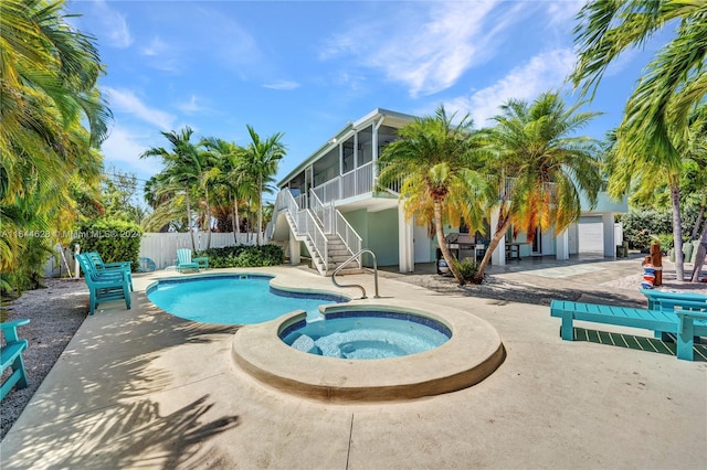 view of pool featuring an in ground hot tub and a patio area