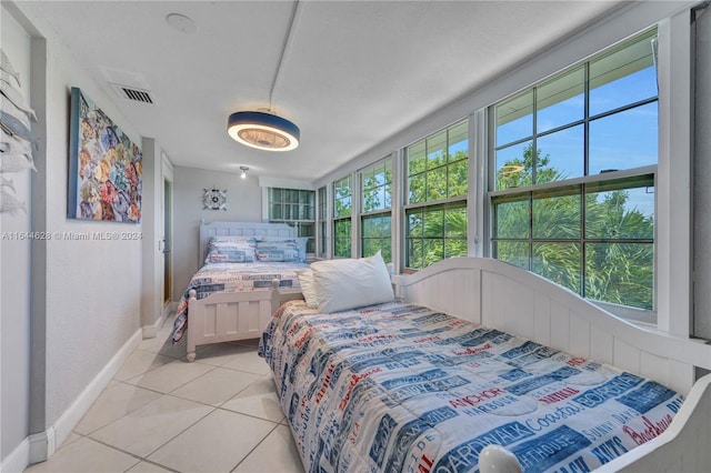 bedroom with light tile patterned floors