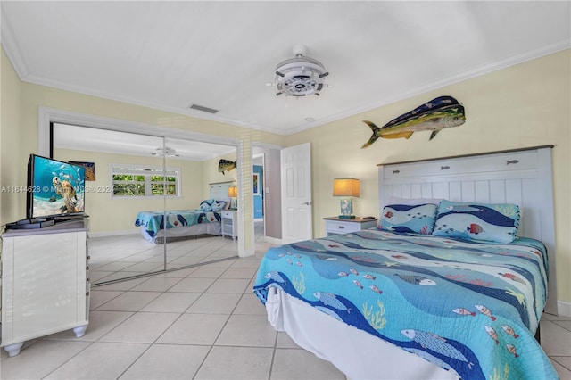 bedroom with ornamental molding and light tile patterned floors