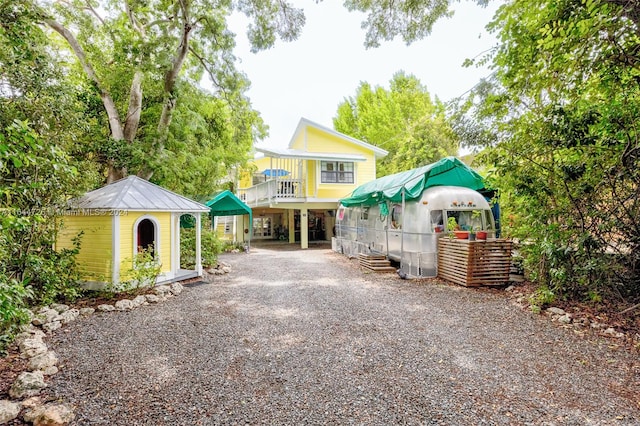 exterior space featuring a balcony and a carport