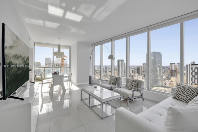 living area with a wealth of natural light, a city view, tile patterned flooring, and baseboards