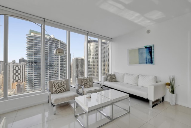 living room featuring a view of city, floor to ceiling windows, and light tile patterned flooring