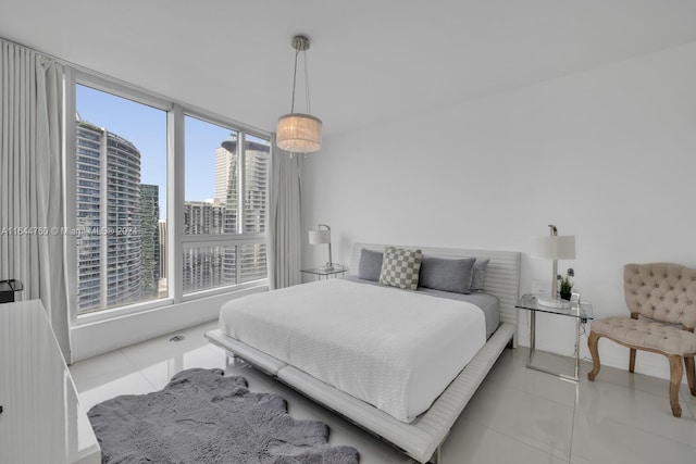 bedroom featuring light tile patterned floors and a city view