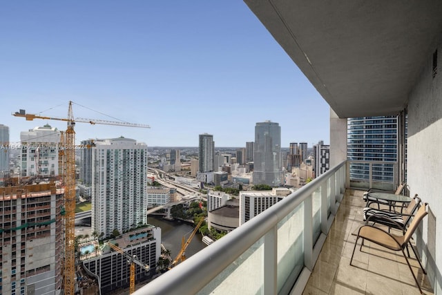 balcony featuring a view of city and a water view