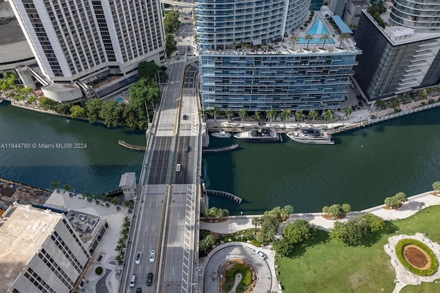 drone / aerial view featuring a city view and a water view