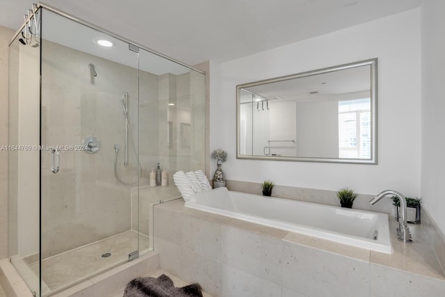 bathroom with shower with separate bathtub