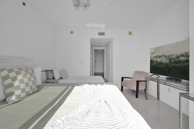 bedroom with light tile patterned floors and visible vents