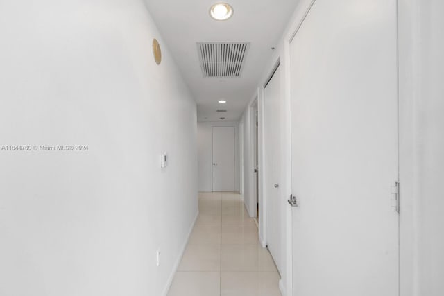 hall featuring recessed lighting, visible vents, baseboards, and light tile patterned flooring