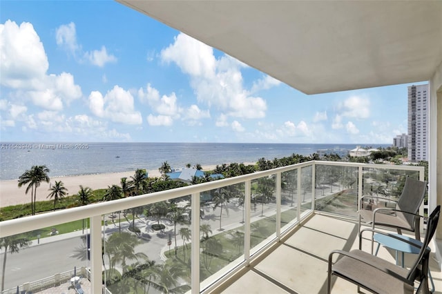 balcony with a water view and a beach view